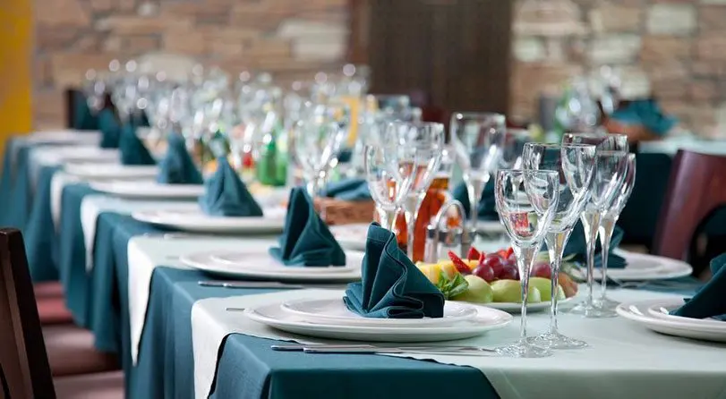 A table set with plates and glasses for a party.