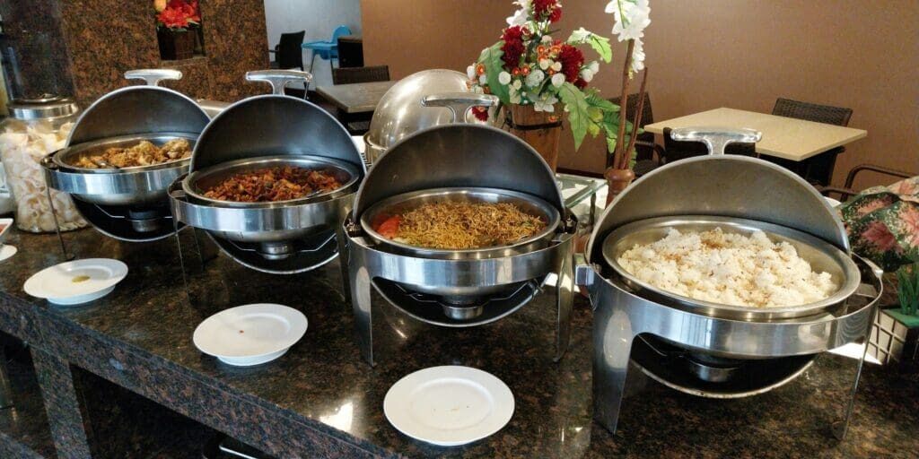 A buffet of food is shown on the counter.